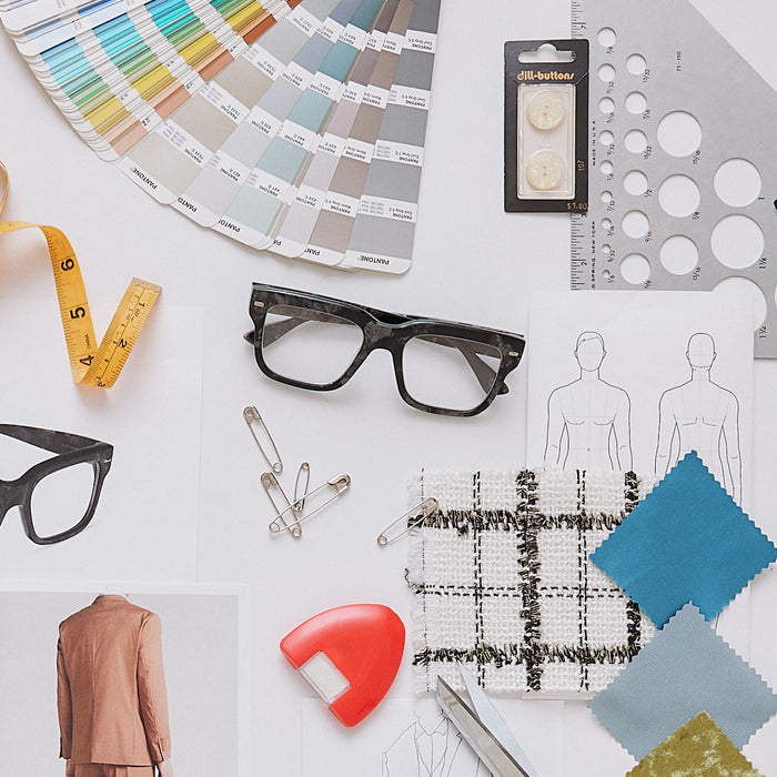 still life of emily in paris x diff eyewear featuring the alfie rectangle prescription glasses with a black tortoise frame surrounded by designer ideas