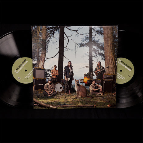 Double vinyl against black background. Vinyl's are black. Jacket is a picture of The Wild Orchid Children standing outside in the woods. There is a panther standing in the center by the band members.