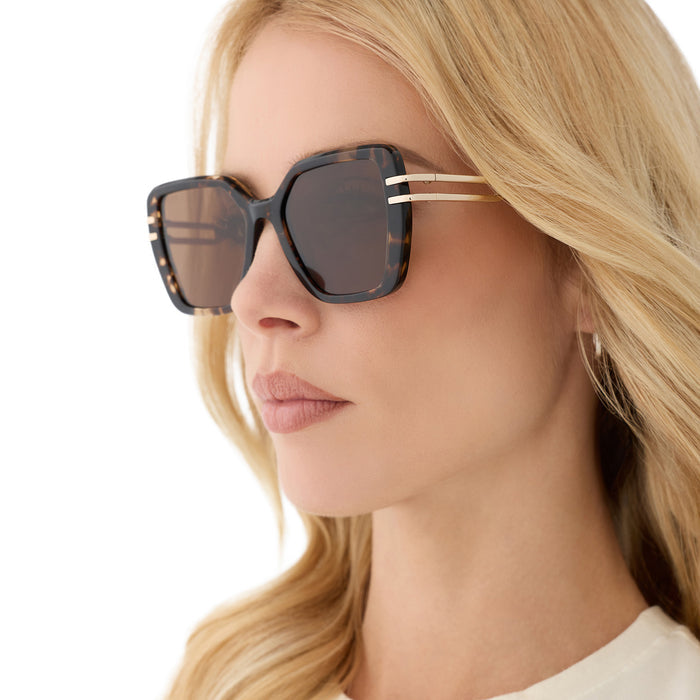 on model - female wearing diff eyewear featuring the dasha square sunglasses with a espresso tortoise with gold frame and brown polarized lenses angled view