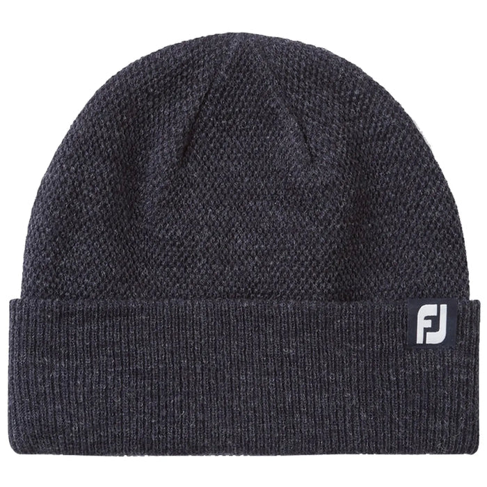 A dark gray knit beanie sits flat showing its textured fabric and folded cuff featuring a small logo tag indicating the brand. The setting is neutral and unobtrusive.