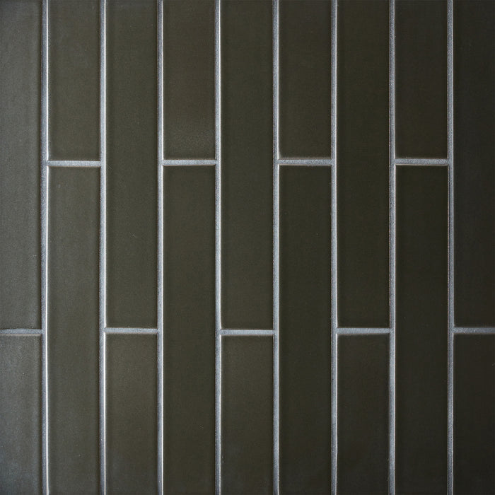 Caption: Classic Field 2x12 in G67 Gunmetal Manganese. Prism Charcoal grout by Custom Building Products.