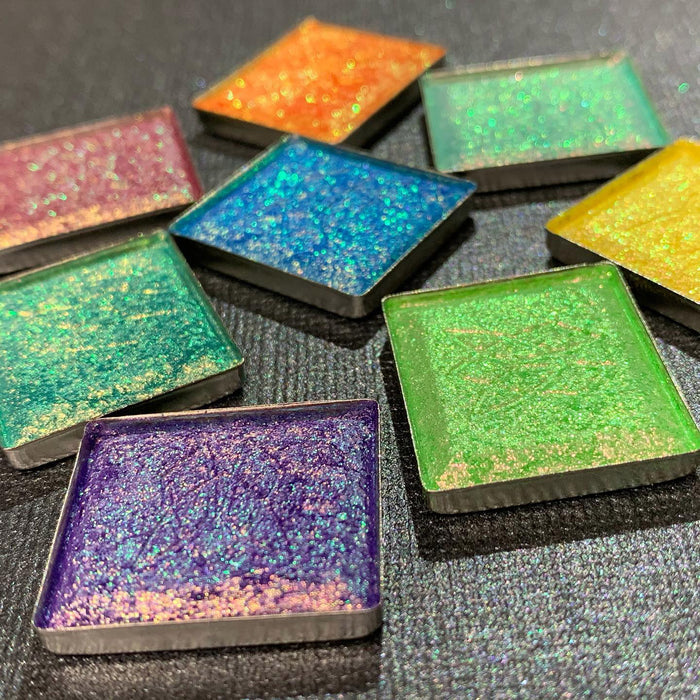 Low angled scattered Heirloom Vibrant Multichrome Eyeshadow pan in Vibrant Multichrome Eyeshadow Bundle with Royalty, Majesty, Throne, Courtyard, Lineage, Crown Jewel, Bloodline