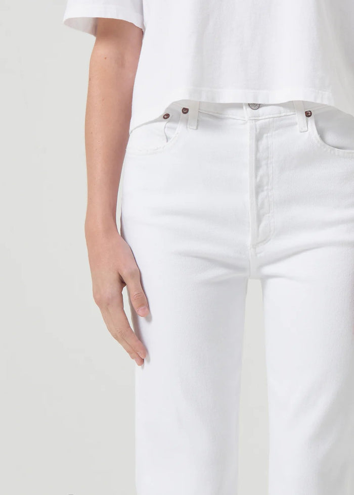 Up close view of agolde women's riley high rise straight crop denim in sour cream. Model is wearing monochromatic outfit.