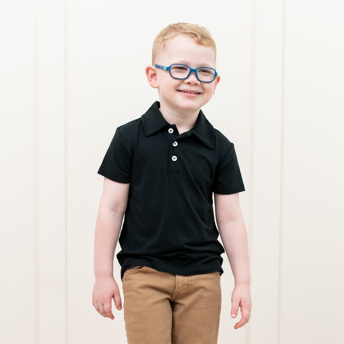 Toddler wearing Kyte Baby Short Sleeve Shirt with Polo Collar in Midnight black
