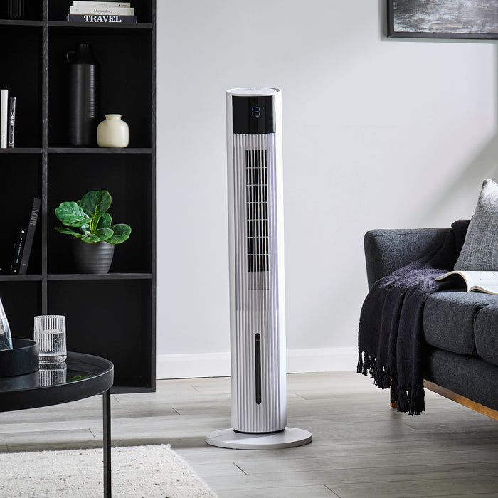 Image showing off the 3-in-1 white Geepas air cooler and tower fan in the middle of a living room.