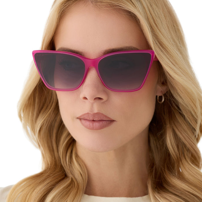 on model - blonde female wearing diff eyewear featuring the alina cat eye sunglasses with a bright pink tulip frame and grey gradient lenses front view