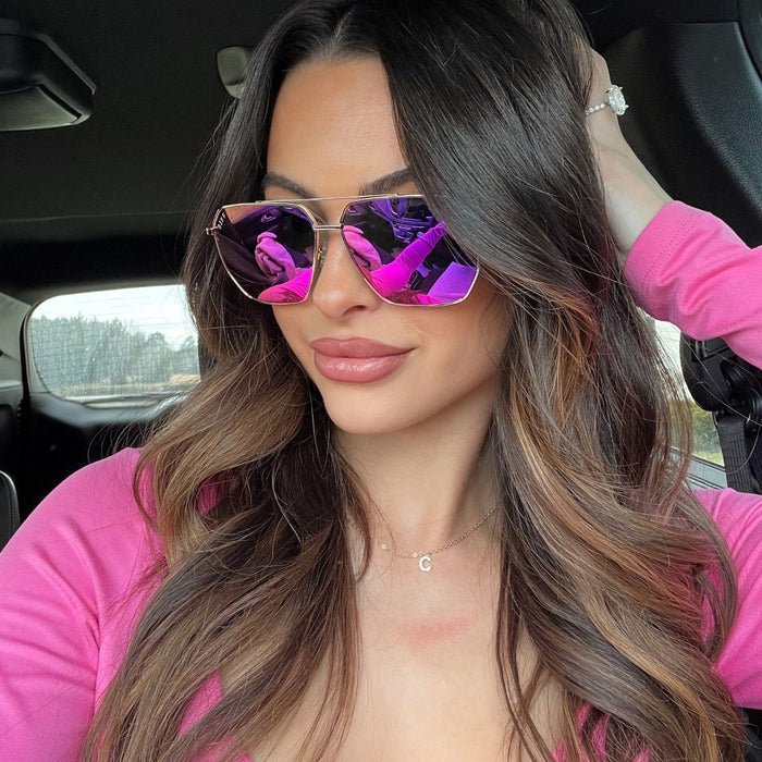 lifestyle - alicia mya brunette model wearing pink reflective mirror navigator sunglasses with gold frame