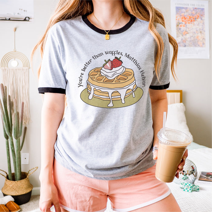 Better Than Waffles Ringer T-shirt - The Bean Workshop - Better than Waffles shirt, Book Lover Gift, Bookish T-shirt, Cozy Aesthetic, Cute Graphic Tee, Grishaverse gift, Helnik, leigh bardugo, Leigh Bardugo fan apparel, Literary Quote, Matthias Helvar merch for readers, Nina Zenik waffle quote shirt, Six of Crows t-shirt, Waffle Illustration