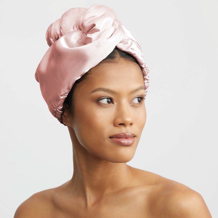 Model wearing the Blush Satin Wrapped Hair Towel against a light gray background