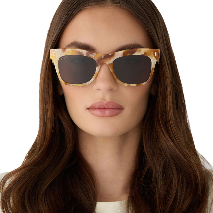on model - female wearing diff eyewear featuring the bradley cateye sunglasses with a gilded tortoise outside and courtside ivory inside acetate frame and brown lenses front view