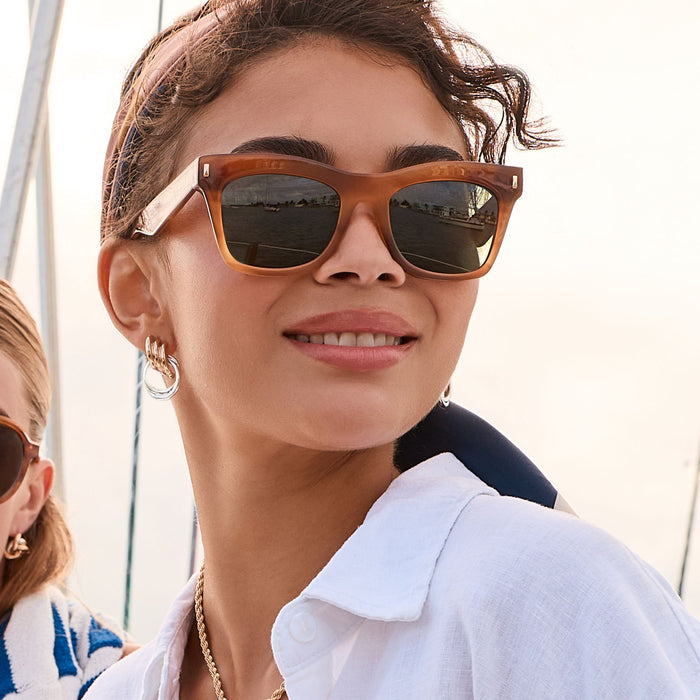 lifestyle - female outdoors wearing diff eyewear bradley cateye sunglasses with a tawny brown tortoise frame and g15 polarized lenses angled view