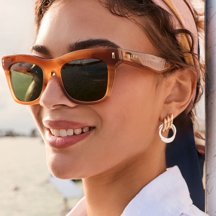 lifestyle - female outdoors wearing diff eyewear bradley cateye sunglasses with a tawny brown tortoise frame and g15 polarized lenses detailed view