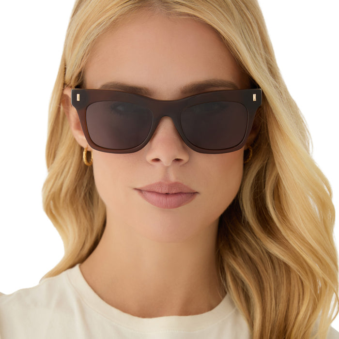 on model - blonde female wearing diff eyewear featuring the bradley cat eye sunglasses with a whiskey brown frame and grey lenses front view