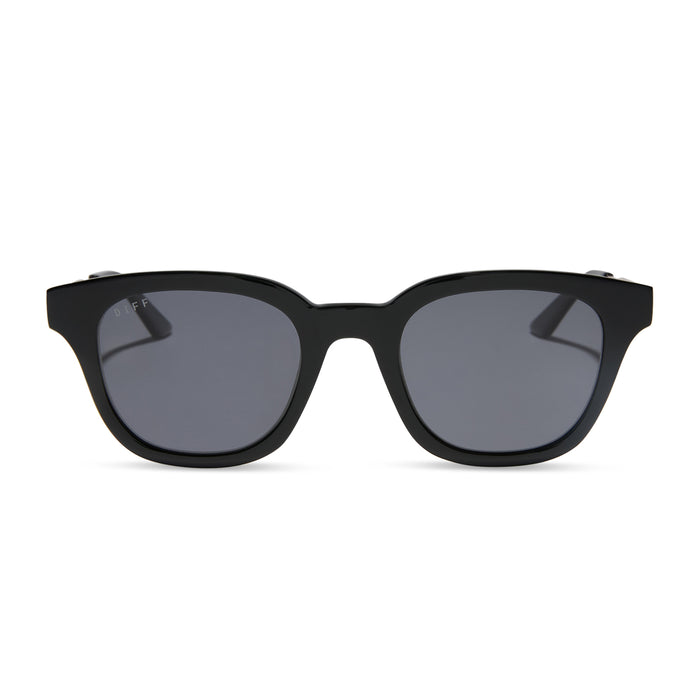 diff eyewear featuring the bridget round sunglasses with a black with gold frame and grey polarized lenses front view