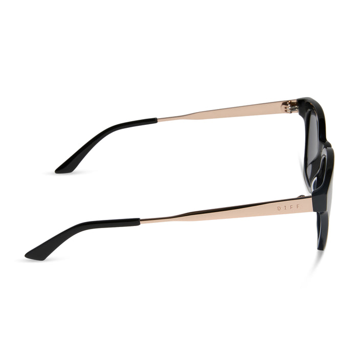 diff eyewear featuring the bridget round sunglasses with a black with gold frame and grey polarized lenses side view