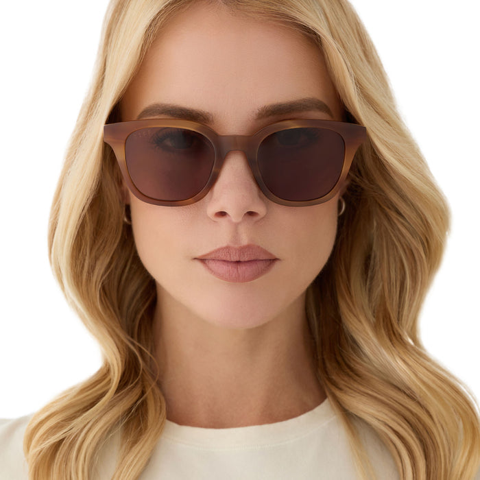 on model - female wearing diff eyewear featuring the bridget round sunglasses with a tawny tortoise frame and brown lenses front view