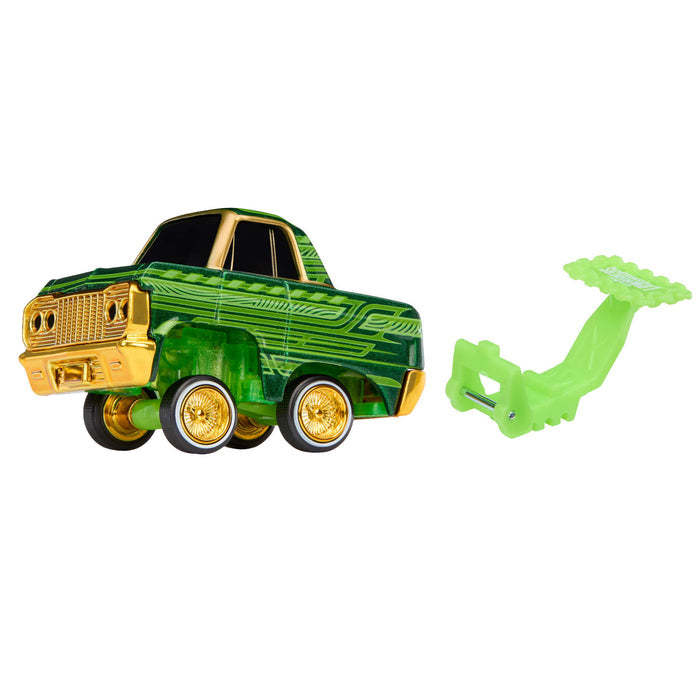 Toy truck with gold accents and a green attachment on a white background