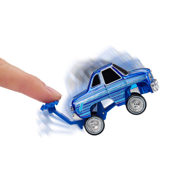 Blue toy car being pushed by a finger on a white background
