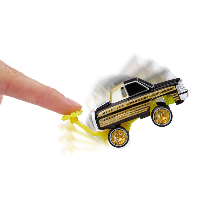 Toy car with a hand pushing it on a white background