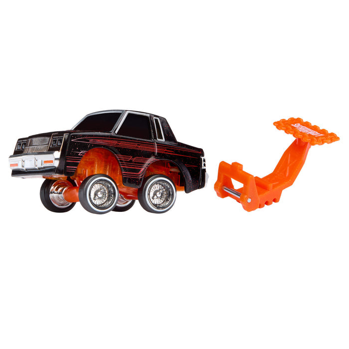 Toy car with a black and red design and an orange attachment on a white background