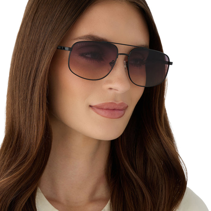 on model - female wearing diff eyewear featuring the charley navigator sunglasses with a shiny black metal frame and twilight gradient lenses angled view