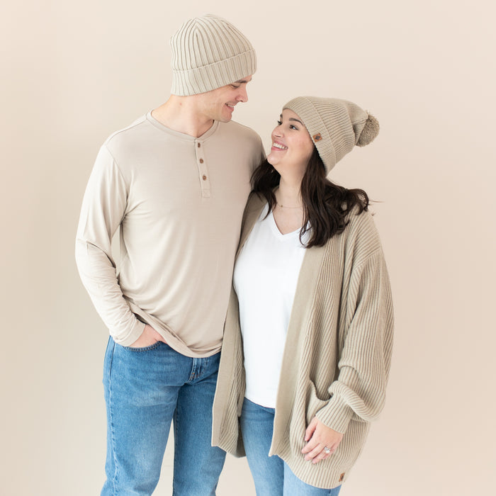 Couple modeling Chunky Knit Adult Ribbed Beanie and Pom Beanie in Almond