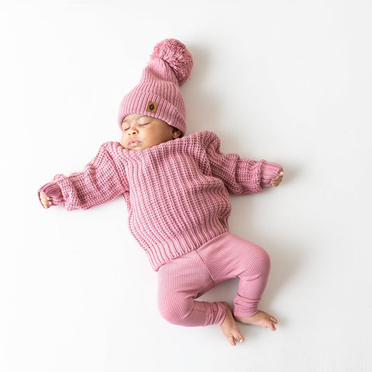 Infant wearing Kyte Baby Chunky Knit Sweater in Apple Blossom