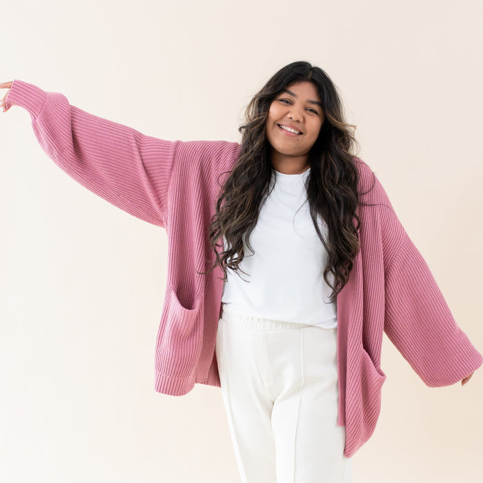 Woman wearing Kyte Baby Chunky Knit Women's Oversized Cardigan in Apple Blossom