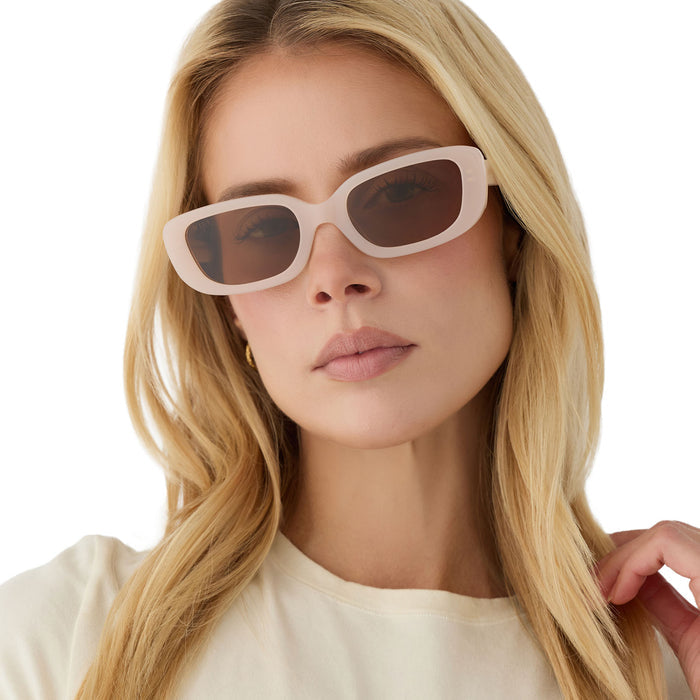 on model - blonde female wearing diff eyewear daphne ii rectangle sunglasses with a milky blush acetate frame and brown polarized lenses front view