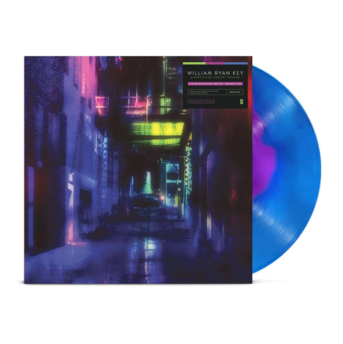 A blue marbled Limited Edition Vinyl by William Ryan Key partially slides out from an album cover displaying a neon-lit, futuristic city alleyway in purple and yellow. A sticker on the cover reads: WILLIAM RYAN KEY / Everything Except Desire.