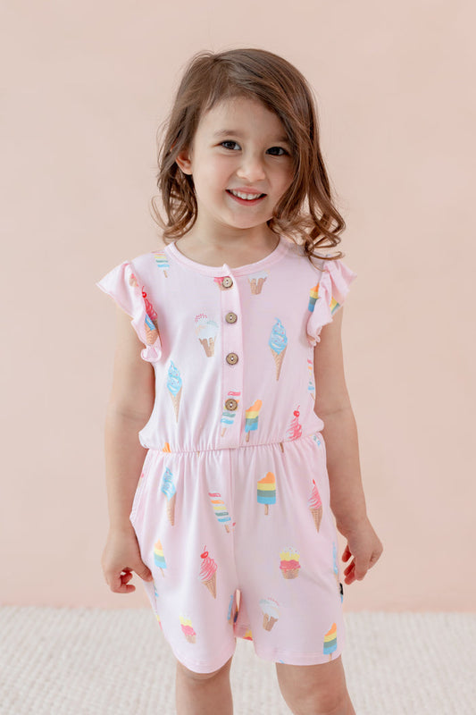 Child smiling in Sakura Ice cream print Flutter Sleeve Romper on a beige background