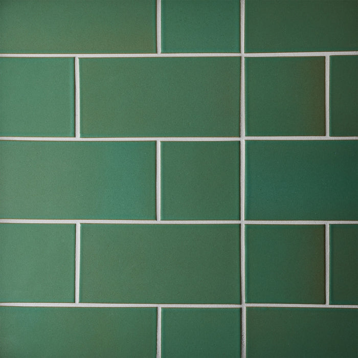 Caption: Classic Field 4x4 & 4x8 in G116 Geyser Green. Prism Natural Grey grout by Custom Building Products.