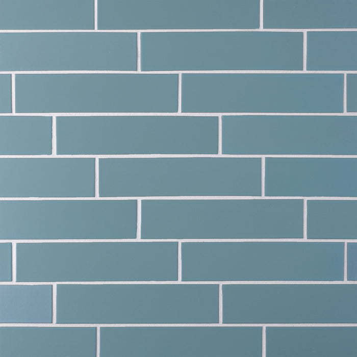 Caption: Classic Field 2x8 in G117 Wave Gloss. Prism Cape Grey grout by Custom Building Products.
