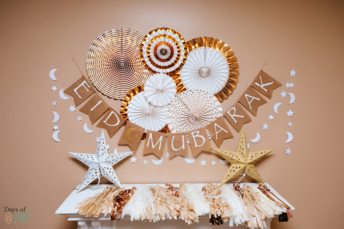 Gold and white garlands and Eid mubarak banner