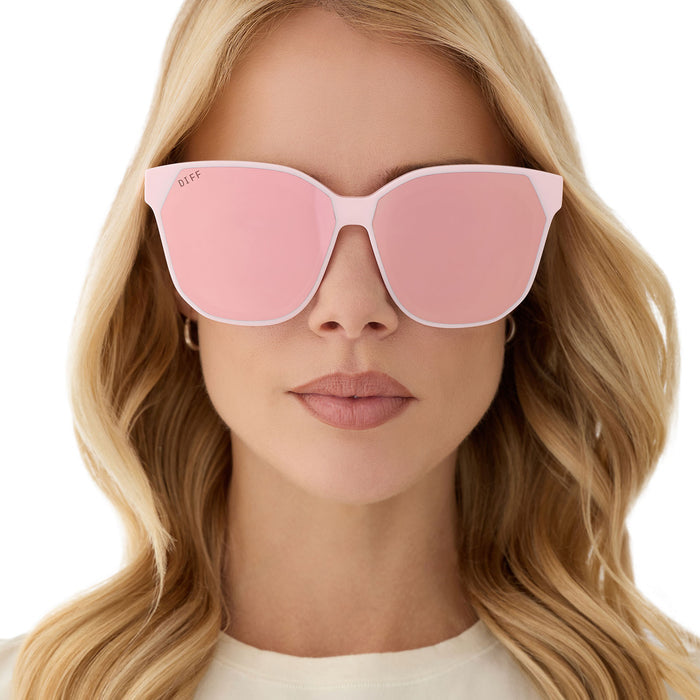 on model - female wearing diff eyewear featuring the gia square sunglasses with a powder pink frame and cherry blossom mirror lenses front view