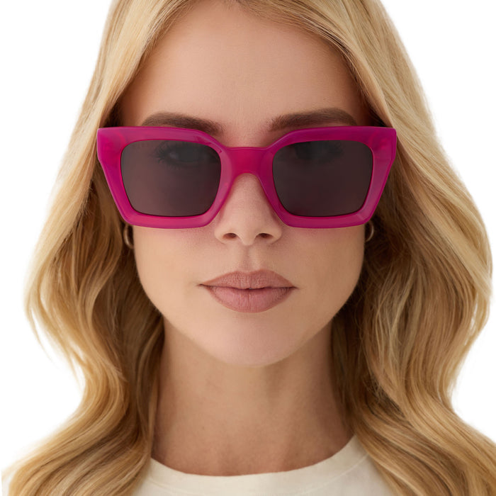 on model - female wearing diff eyewear featuring the greer square sunglasses with a bright tulip pink frame and grey lenses front view