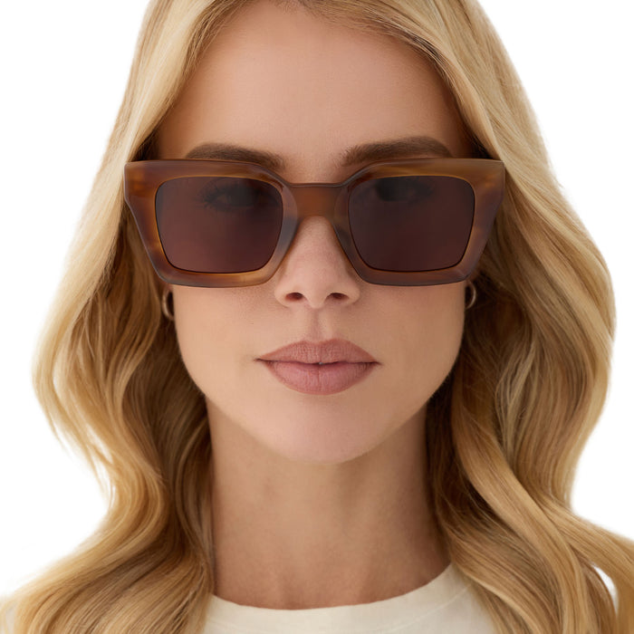 on model - female wearing diff eyewear featuring the greer square sunglasses with a tawny tortoise frame and brown lenses front view