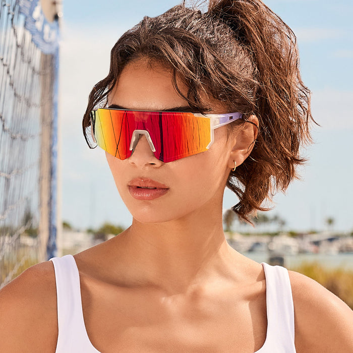 lifestyle - female playing beach volleyball with diff sport heat shield sunglasses with a crystal clear frame and rainbow mirror polarized lenses
