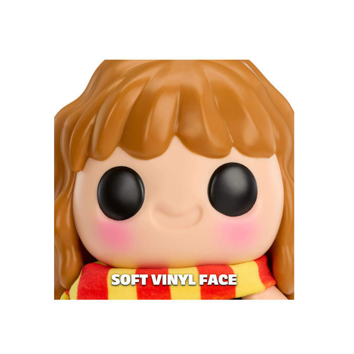 Toy figure with brown hair and a soft vinyl face, wearing a red and yellow scarf.