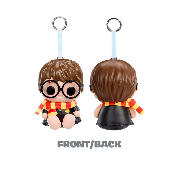 Keychain figure of a character with brown hair, glasses, and a red and yellow scarf on a white background.