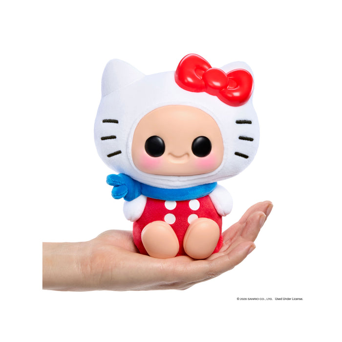 Small figurine of a character with a red bow and red outfit held in a hand against a white background