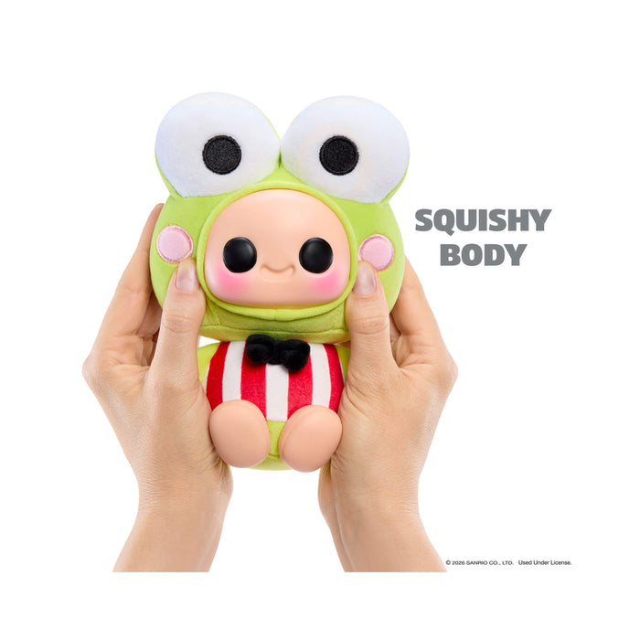 Squishy toy with a green face and striped body held by hands on a white background