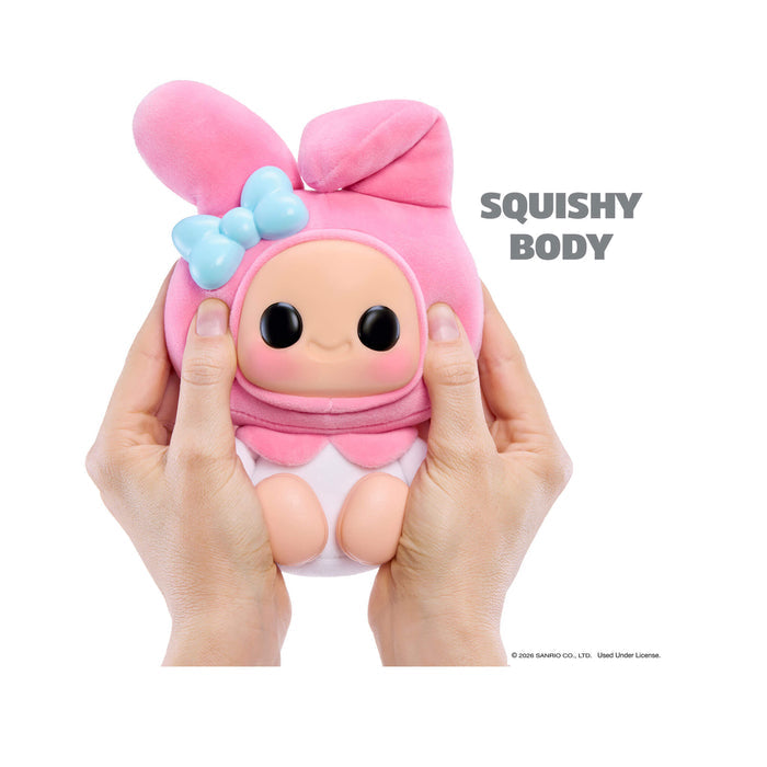 Pink plush toy with a bow held by hands on a white background, labeled 'Squishy Body'.