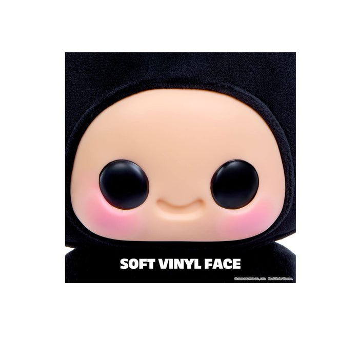 Soft vinyl face figure with black hair on a white background