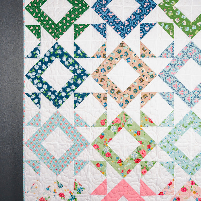 Colorful quilt with geometric pattern on a dark background