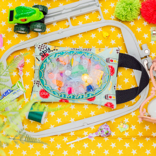 Toy car track set with colorful toys on a yellow star-patterned background