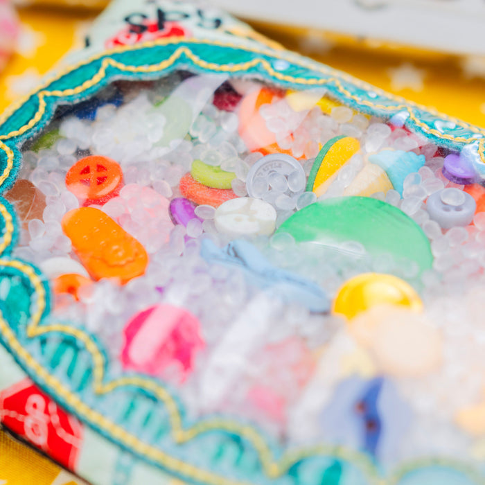 Children's toy with colorful beads and toys on a yellow background with stars