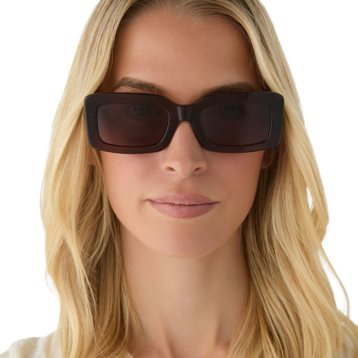 on model - female wearing diff eyewear  featuring the indy rectangular sunglasses with a whiskey brown frame and brown polarized lenses front view