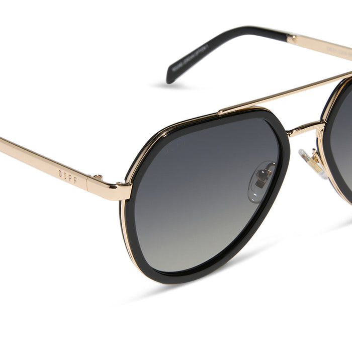 diff eyewear featuring the joey round sunglasses with a black & gold metal frame with grey gradient polarized lenses detailed view