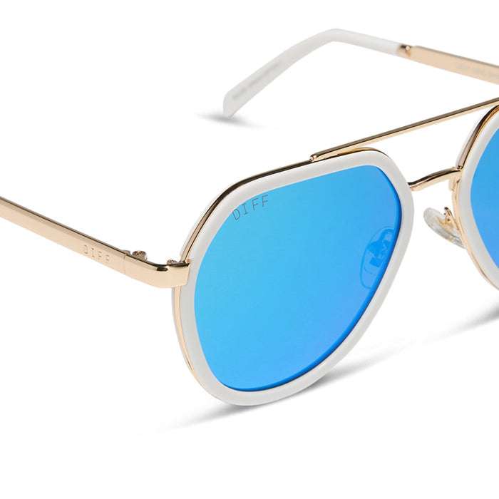 diff eyewear featuring the joey round sunglasses with a snowbound & gold metal frame with blue mirror lenses detailed view